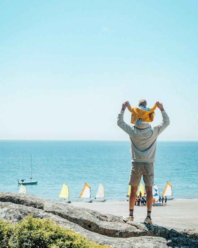 Un père et son fils face à la mer à Névez